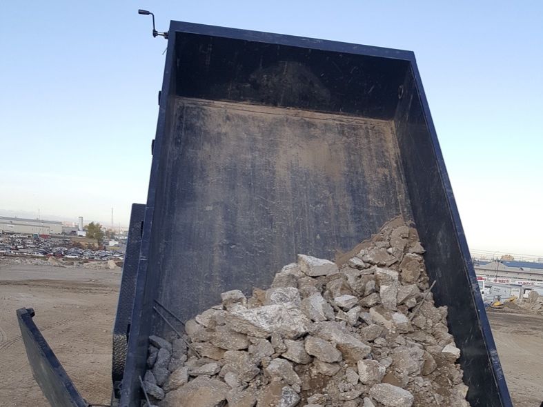 Broken concrete being unloaded for disposal.
