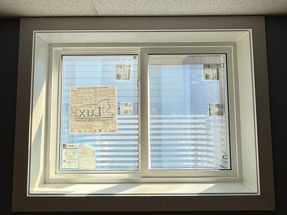 White sliding basement window with finished interior trim.