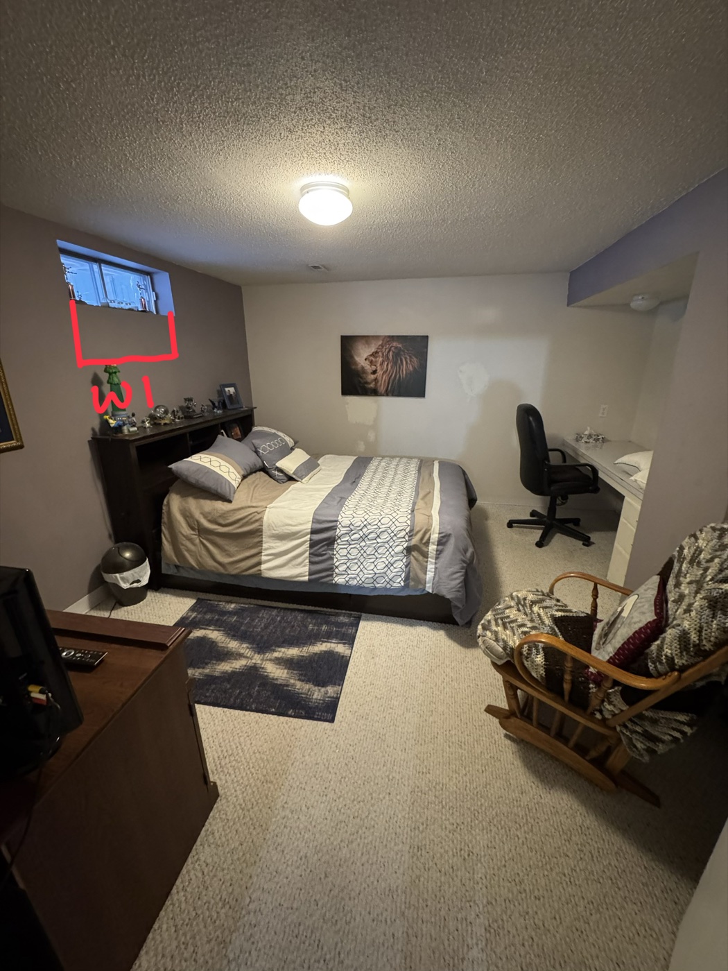 Basement bedroom with existing small non-egress window — Calgary before replacement