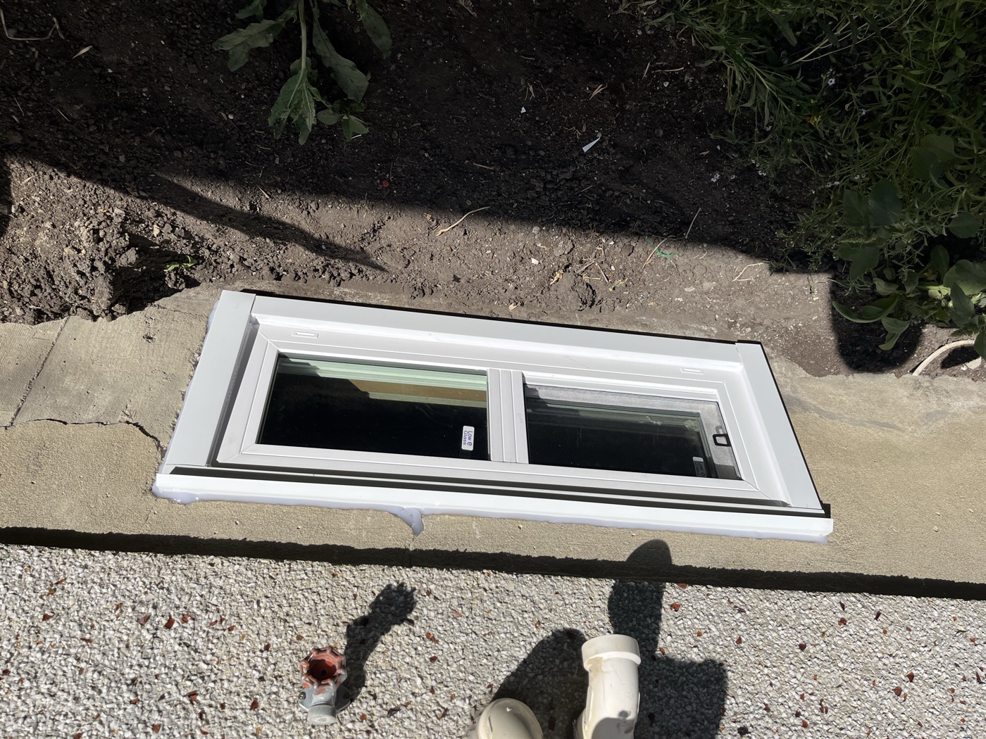 Completed egress window exterior installation — Calgary home
