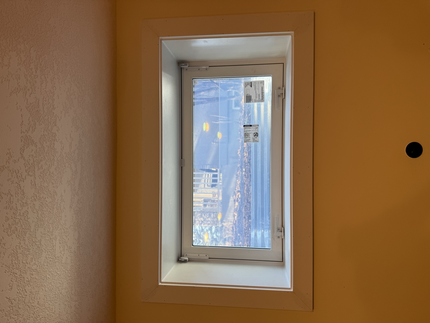 Interior egress window finishing — white melamine trim and casement, Calgary basement
