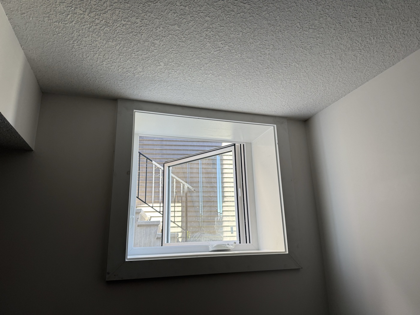 Interior egress window casement trim finished — Calgary home