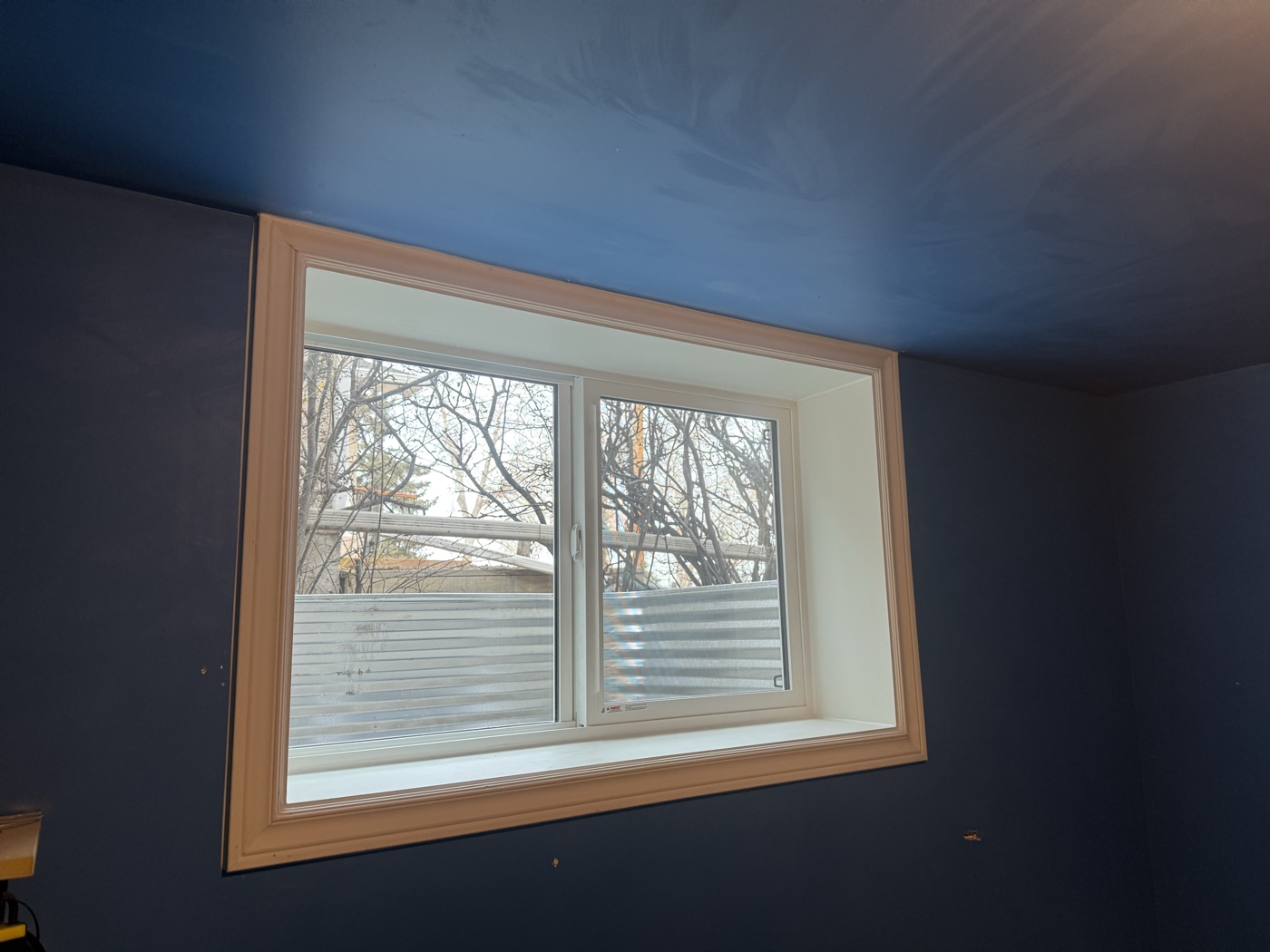 Interior finished egress window — white trim, Calgary basement